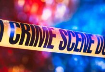 Serial Killer Panic? Cops Won’t Say Crime scene tape with blurred emergency lights in background