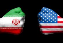 U.S. – Iran Clash Escalates In Crucial Strait Fists painted as Iran and United States flags facing each other