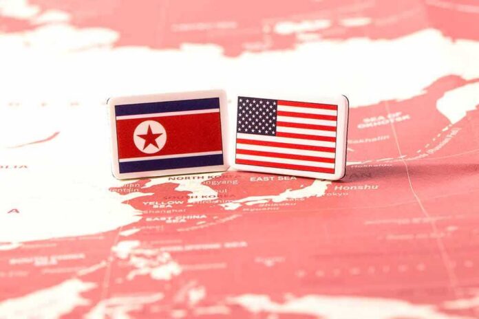 shutterstock_1090158029 Flags of North Korea and the United States on a map of East Asia