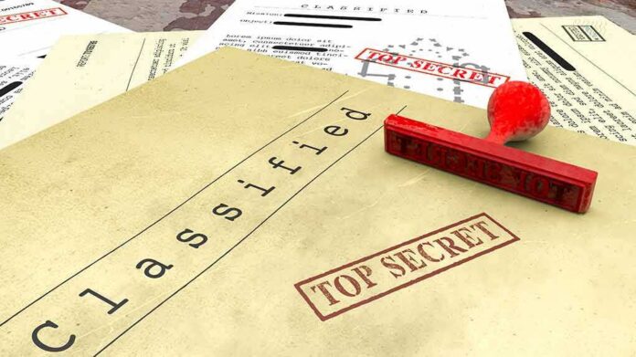 shutterstock_1099380299 Classified documents with red Top Secret stamp and rubber stamp