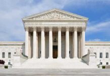 Trump TORCHES His Own Justices Front view of the Supreme Court building with large columns and steps under a blue sky
