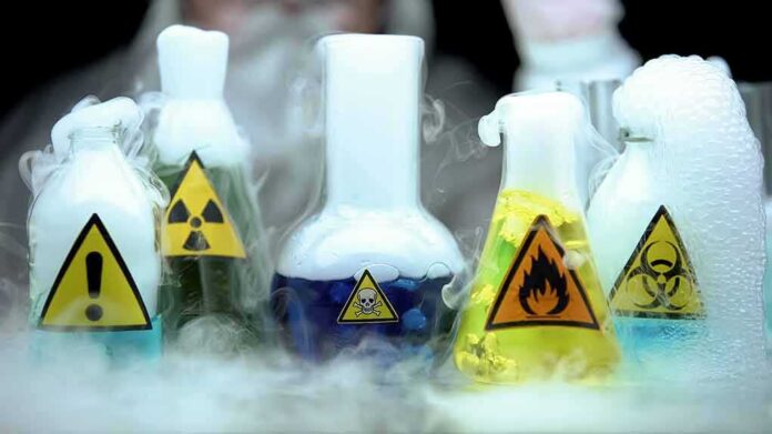laboratory flasks with hazard symbols and colorful liquids