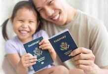 Smiling child and adult holding passports