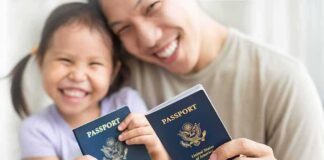 Smiling child and adult holding passports