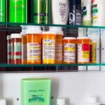 Most-Favored Price Bombshell Hits Pharma Medicine cabinet with prescription bottles and toiletries
