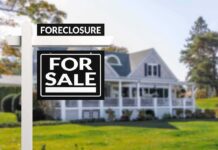 for sale sign in front of suburban house