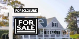 for sale sign in front of suburban house