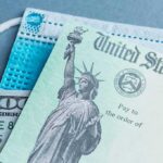 U.S. Treasury check with face mask and hundred-dollar bill