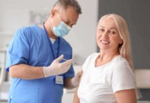 Shingles Vaccine’s Hidden Heart Edge Smiling woman receiving a vaccination from a healthcare worker