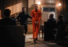 Double Murder, No Death – What Gives? Inmate in orange jumpsuit escorted by officer in courtroom