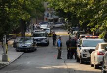 Two Ole Miss Deaths, One Chilling Common Link Police officers secure a residential street with patrol cars and yellow tape