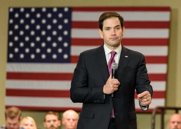 man in suit speaking into a microphone