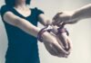 Person being handcuffed with hands extended forward
