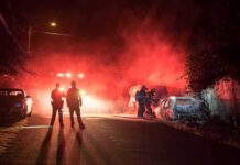 Pub Inferno: Dozens Trapped Firefighters and police at a nighttime car fire scene