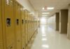 Row of yellow school lockers in an empty hallway