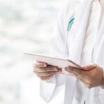 Trump Lights Up ‘Doctor’ Controversy Doctor with stethoscope using a tablet