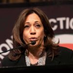 Kamala Harris’s Ruthless Power Play: 13-Justice Court? woman speaking at a podium with microphone