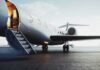 Private jet on tarmac with open door and boarding stairs