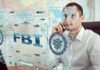 Man on phone behind digital interface with FBI and cybersecurity graphics