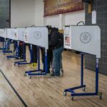 Same-Name Gambit Explodes In Alaska Voters at polling booths in a gymnasium