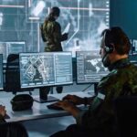 Hegseth Slashes Brass, Builds Bot Army Military analysts at computers in a command center