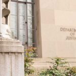 Ghost Payroll Scandal Snags County Tax Chief Department of Justice building facade with stone sign and window